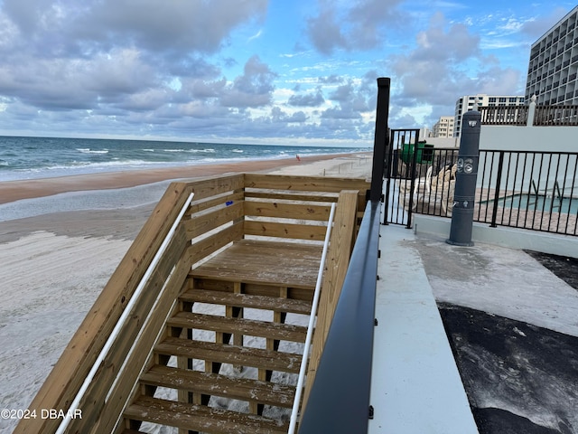 view of community featuring a beach view and a water view