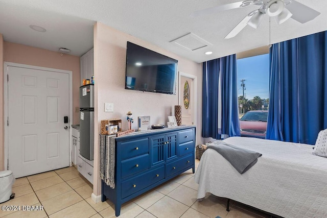 bedroom featuring stainless steel fridge, light tile patterned floors, a textured ceiling, and ceiling fan