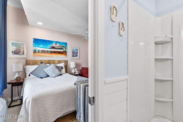 bedroom featuring ceiling fan and a textured ceiling