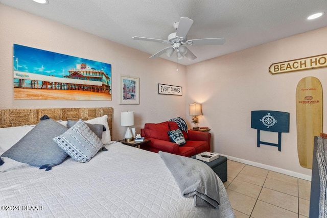 tiled bedroom featuring ceiling fan and a textured ceiling