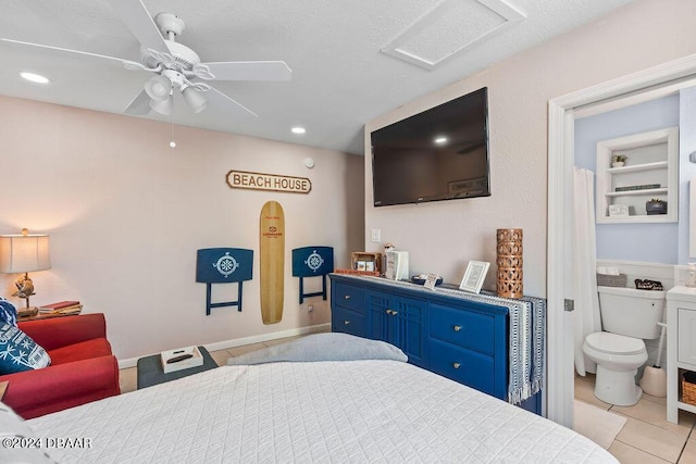 tiled bedroom with ceiling fan and connected bathroom