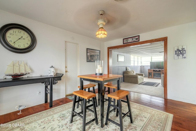 dining area with ceiling fan and hardwood / wood-style flooring