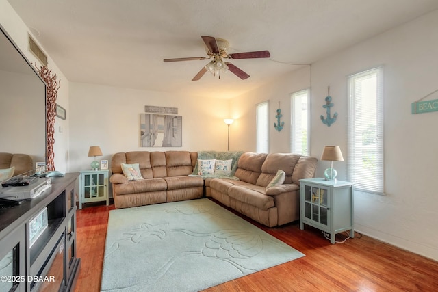 living room featuring hardwood / wood-style floors and ceiling fan