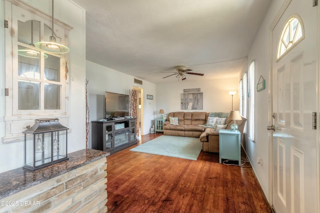 living room with ceiling fan and dark hardwood / wood-style floors