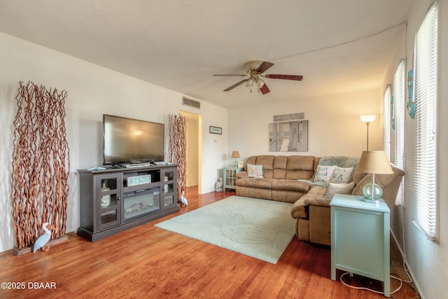 living room featuring ceiling fan and wood-type flooring