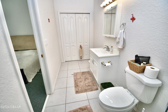 bathroom featuring toilet, vanity, and tile patterned floors