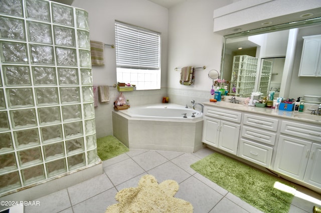 bathroom with tile patterned flooring, vanity, and plus walk in shower