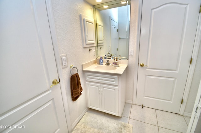 bathroom with tile patterned floors and vanity