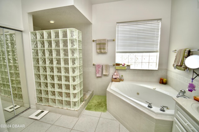 bathroom with tile patterned flooring, vanity, and independent shower and bath