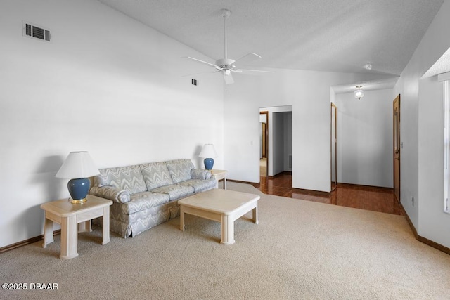 unfurnished living room with high vaulted ceiling, carpet, visible vents, and a ceiling fan