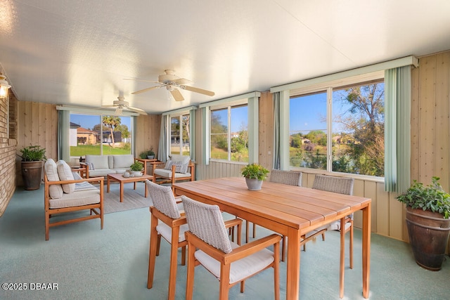 sunroom featuring a ceiling fan