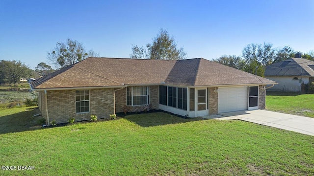 single story home with brick siding, a shingled roof, an attached garage, a front yard, and driveway