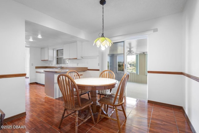 dining space with dark wood-style floors and baseboards