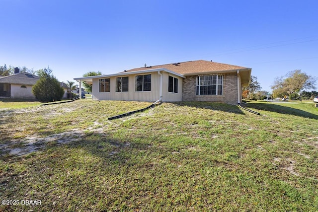 view of front of property featuring brick siding and a front yard