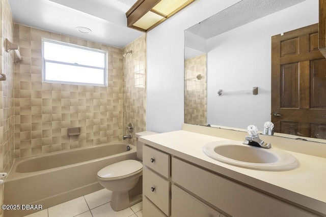 bathroom featuring toilet, vanity, tile patterned flooring, and washtub / shower combination