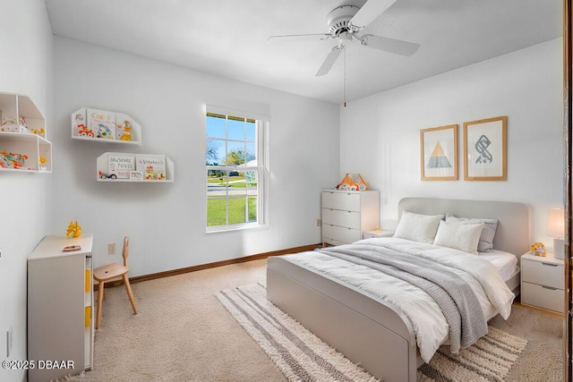 carpeted bedroom with ceiling fan and baseboards