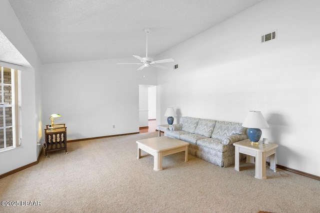 carpeted living area with visible vents, vaulted ceiling, and baseboards