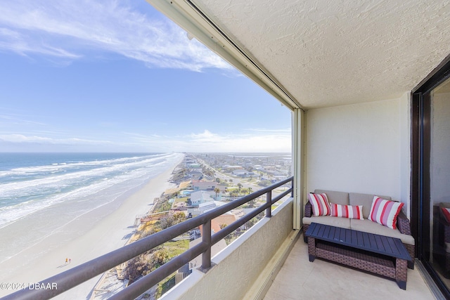 balcony featuring a water view and a view of the beach