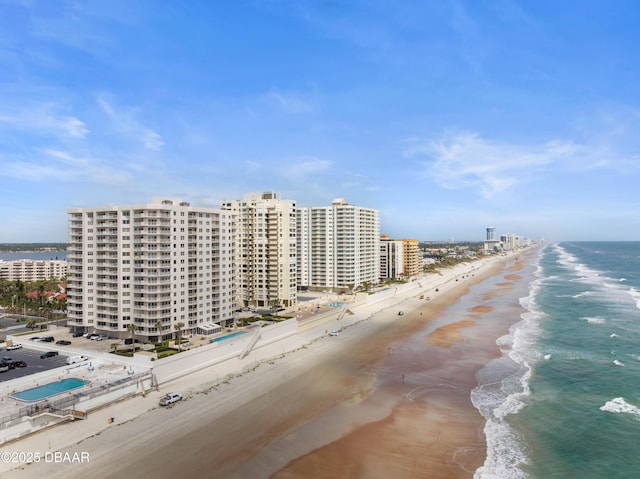 birds eye view of property featuring a view of the beach and a water view