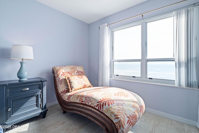 bedroom with wood finished floors and baseboards
