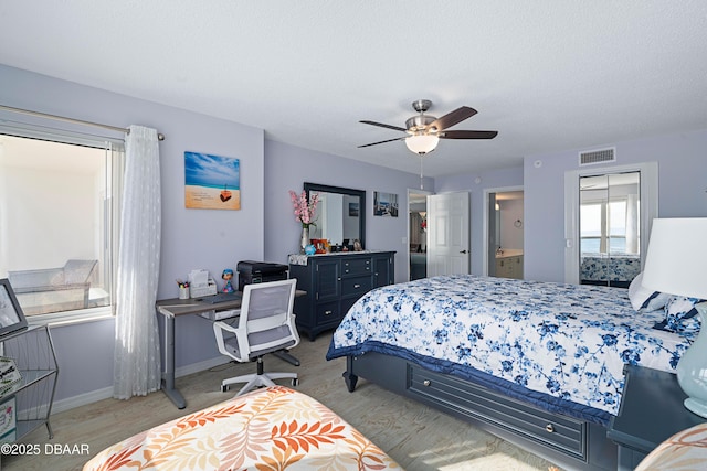 bedroom with baseboards, visible vents, wood finished floors, and ceiling fan