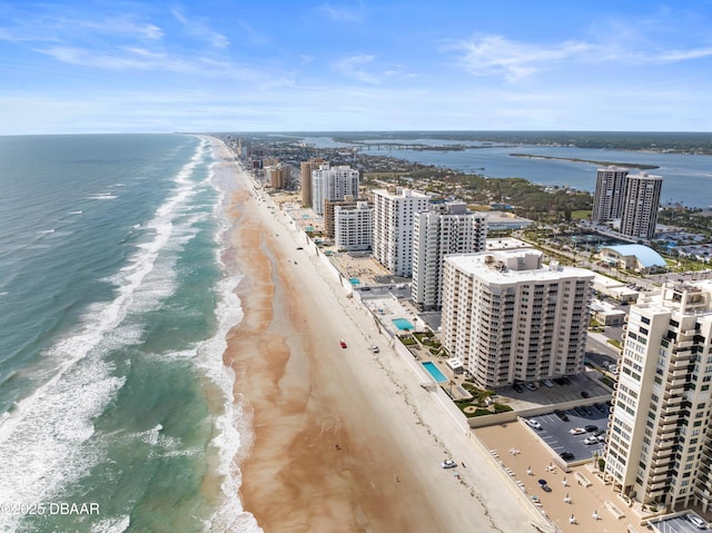 birds eye view of property with a beach view, a city view, and a water view