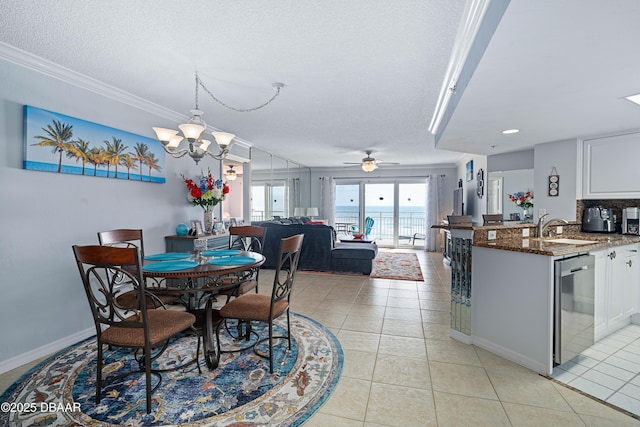 dining space with light tile patterned floors, ceiling fan with notable chandelier, a textured ceiling, and ornamental molding
