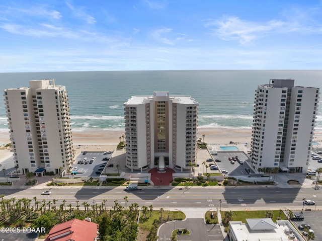 drone / aerial view featuring a beach view and a water view