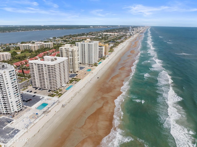 drone / aerial view featuring a beach view and a water view