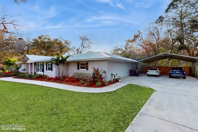 view of property exterior with a garage, concrete driveway, metal roof, a yard, and a carport