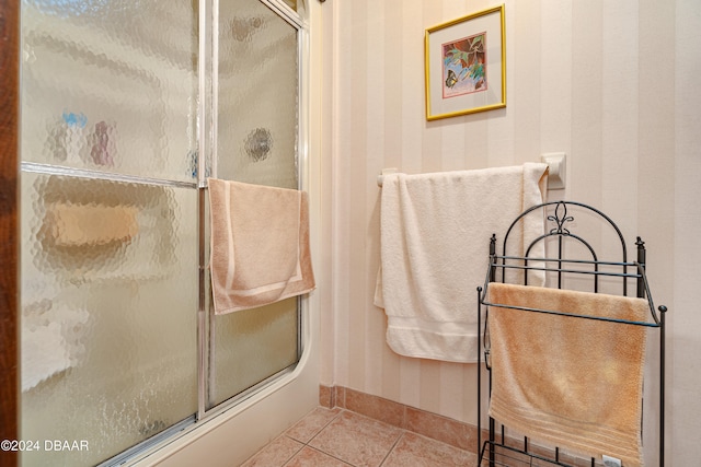 bathroom with tile patterned flooring and walk in shower