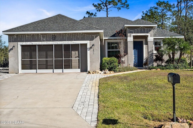 view of front of home with a front yard and a garage