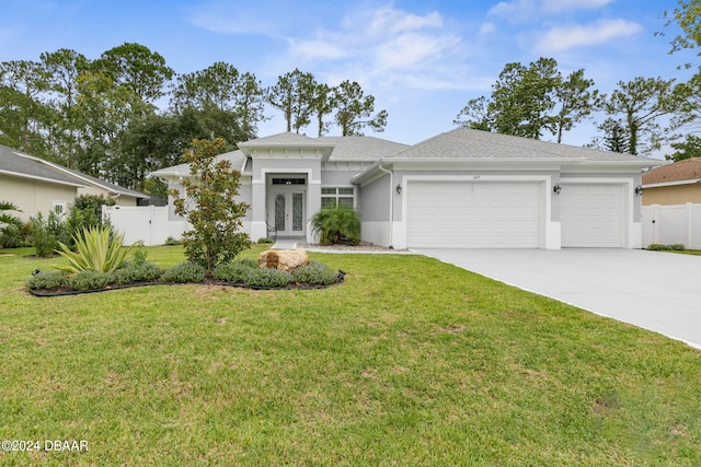 ranch-style house with a garage and a front lawn