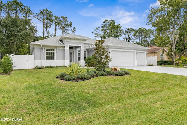 view of front of home with a garage and a front lawn