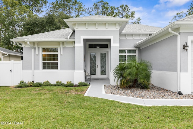 doorway to property with a yard and french doors