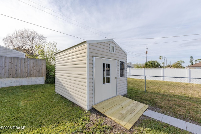 view of outbuilding with a yard