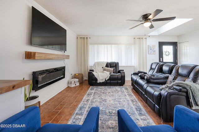 living room featuring ceiling fan and crown molding