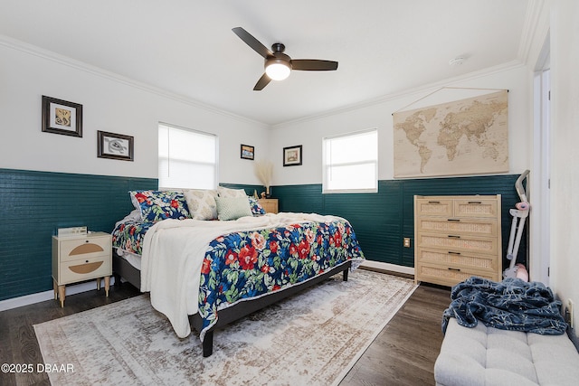 bedroom featuring ceiling fan, crown molding, and dark wood-type flooring