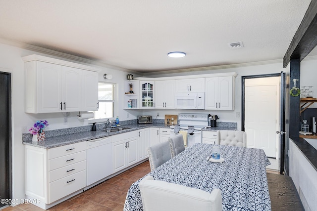 kitchen featuring white appliances, white cabinets, sink, ornamental molding, and dark stone counters