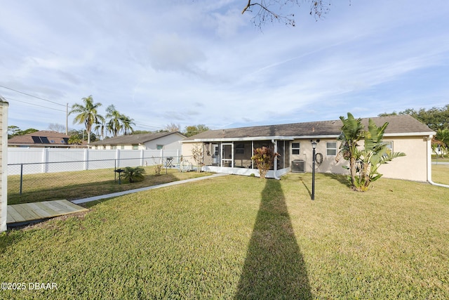 view of front facade featuring a sunroom, cooling unit, and a front lawn