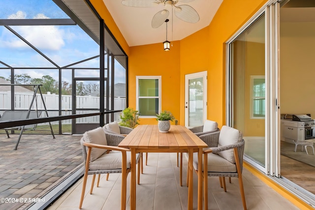 sunroom with vaulted ceiling, ceiling fan, and a healthy amount of sunlight