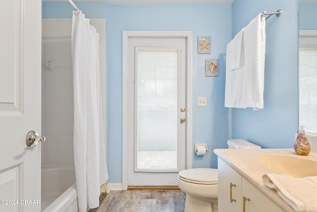 full bathroom with vanity, toilet, wood-type flooring, and shower / tub combo with curtain