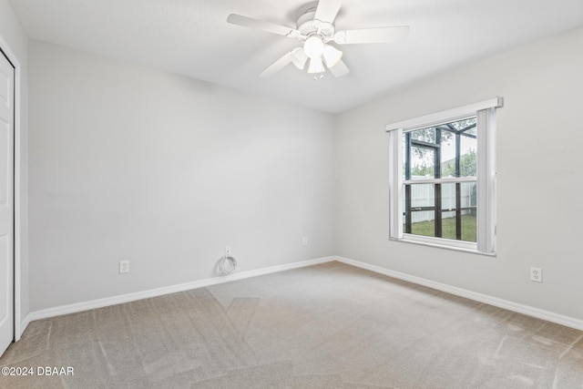 unfurnished room featuring ceiling fan and carpet floors