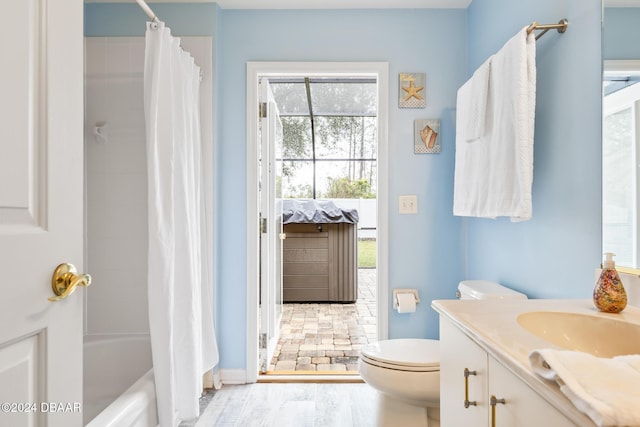 full bathroom with shower / bathtub combination with curtain, vanity, wood-type flooring, and toilet