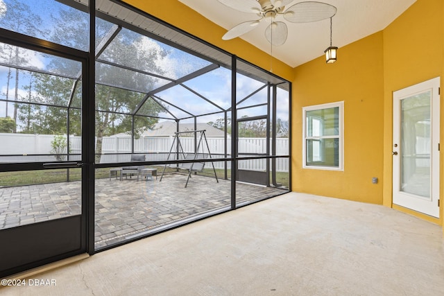 unfurnished sunroom with ceiling fan