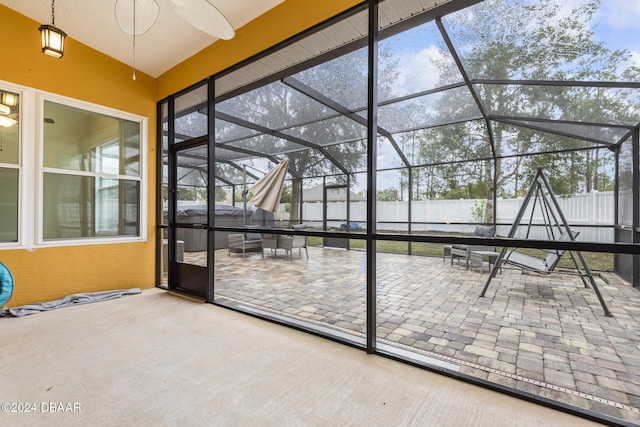 unfurnished sunroom featuring lofted ceiling