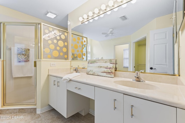 bathroom featuring tile patterned flooring, ceiling fan, a shower with shower door, and vanity