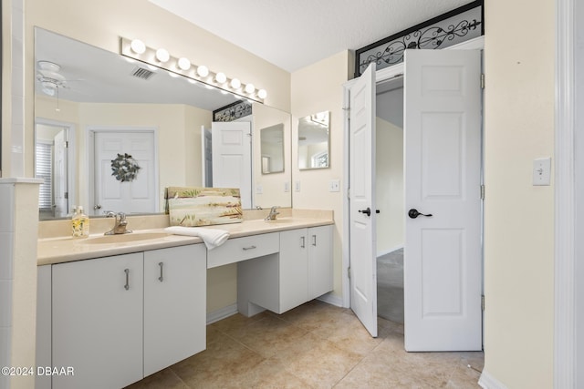 bathroom with ceiling fan, a textured ceiling, and vanity