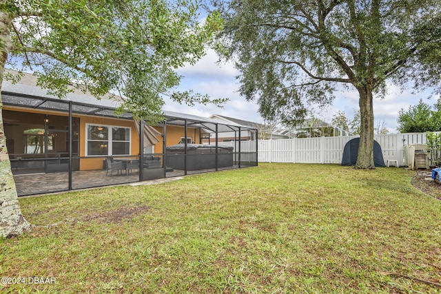 view of yard with a patio, a hot tub, and a lanai