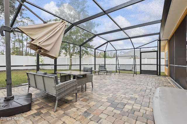 view of patio / terrace featuring glass enclosure